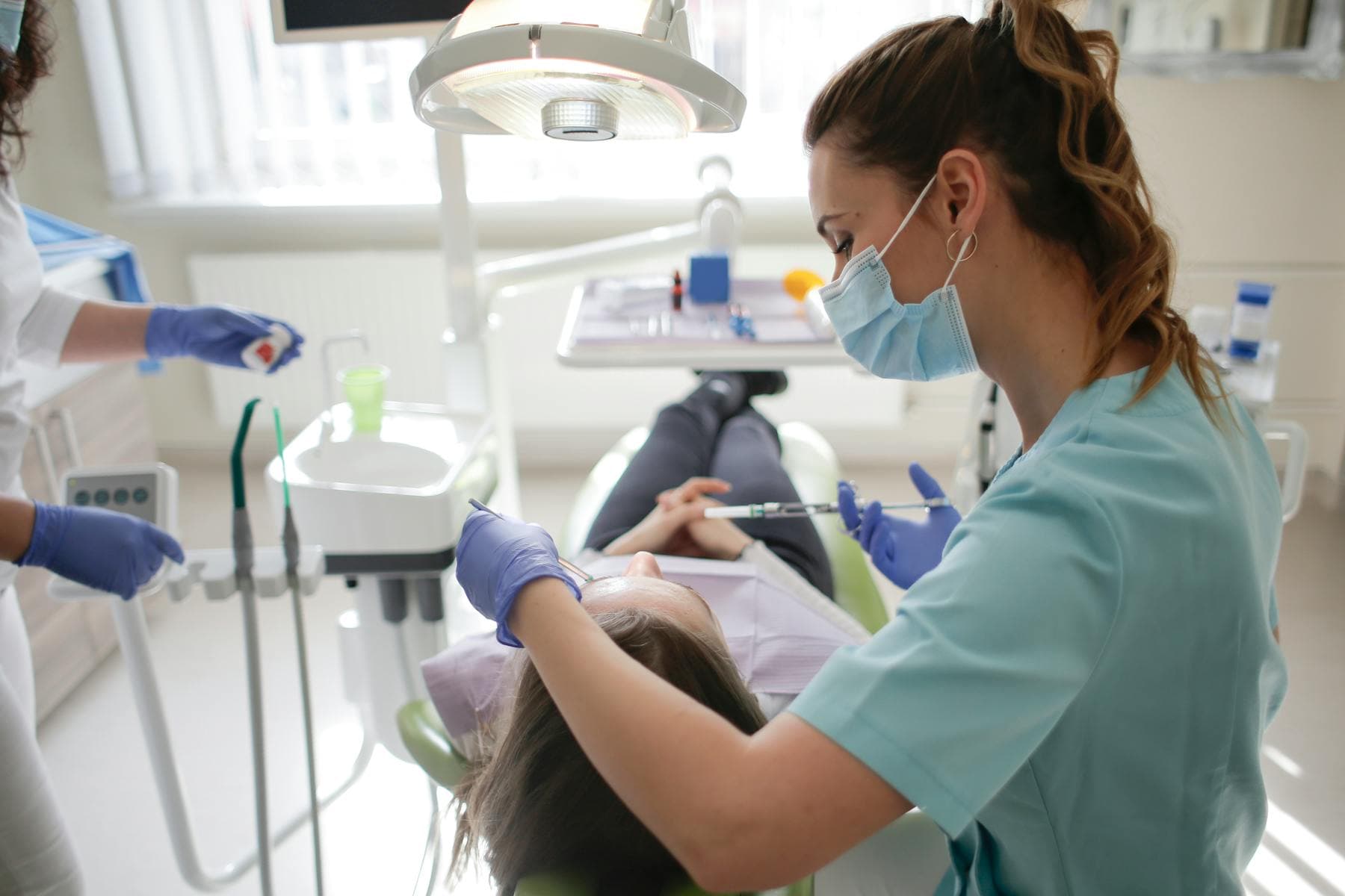 A Dental Hygienist treating a patient at EPSUM, Madrid